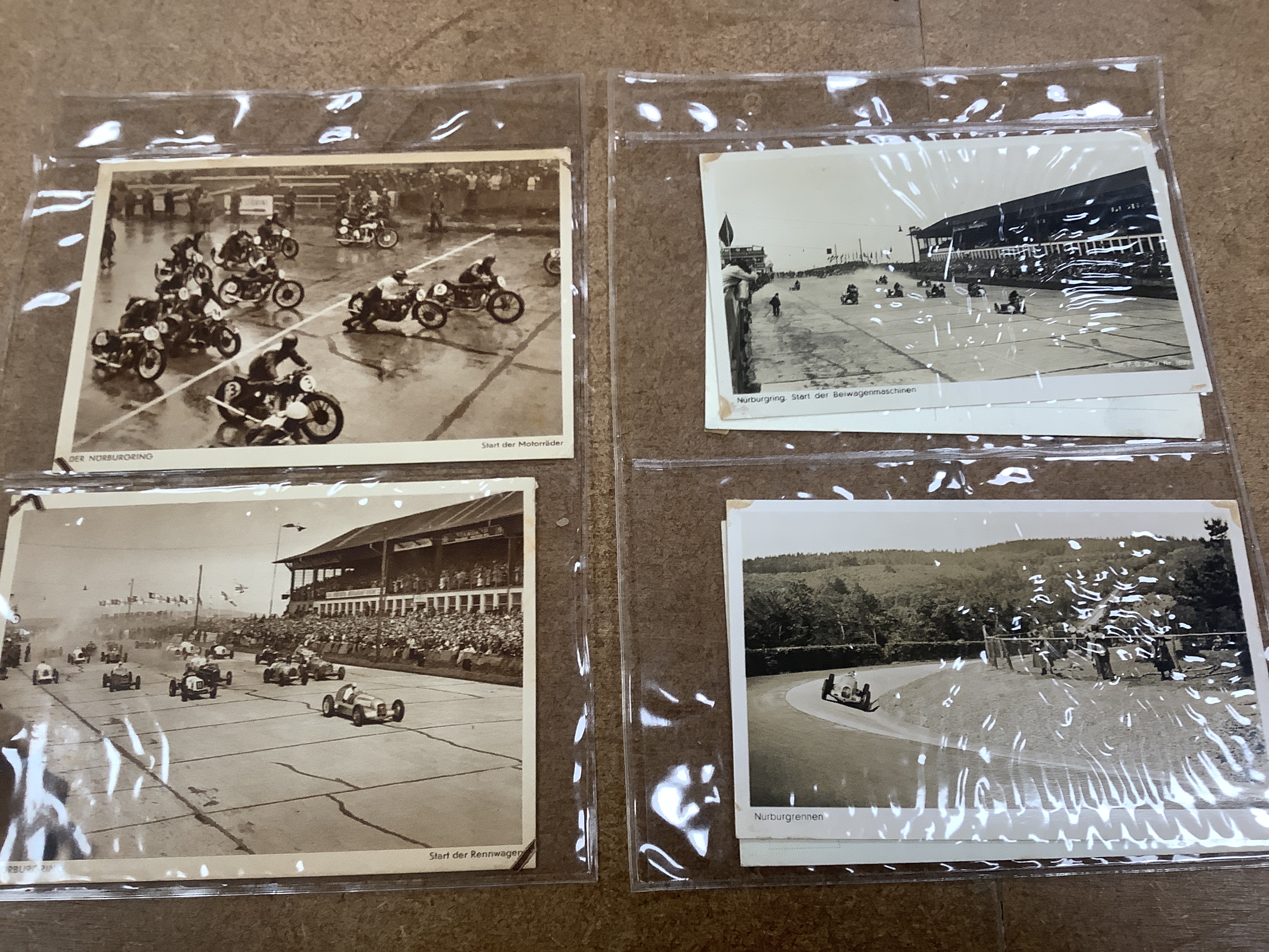 A postcard album, largely continental topography, and eight cards relating to car and motorcycle racing